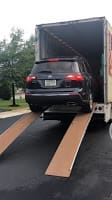 A black sedan going into a truck