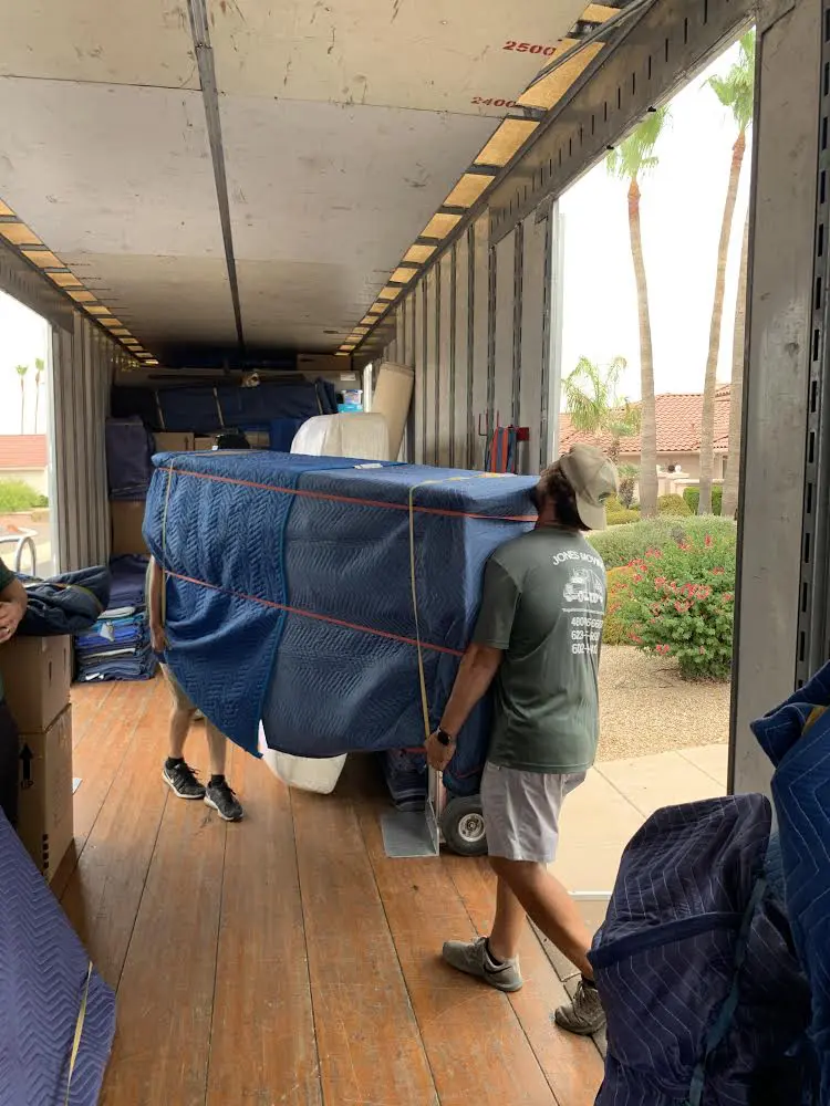 A moving truck with a bed in the back, ideal for movers in Phoenix, AZ.